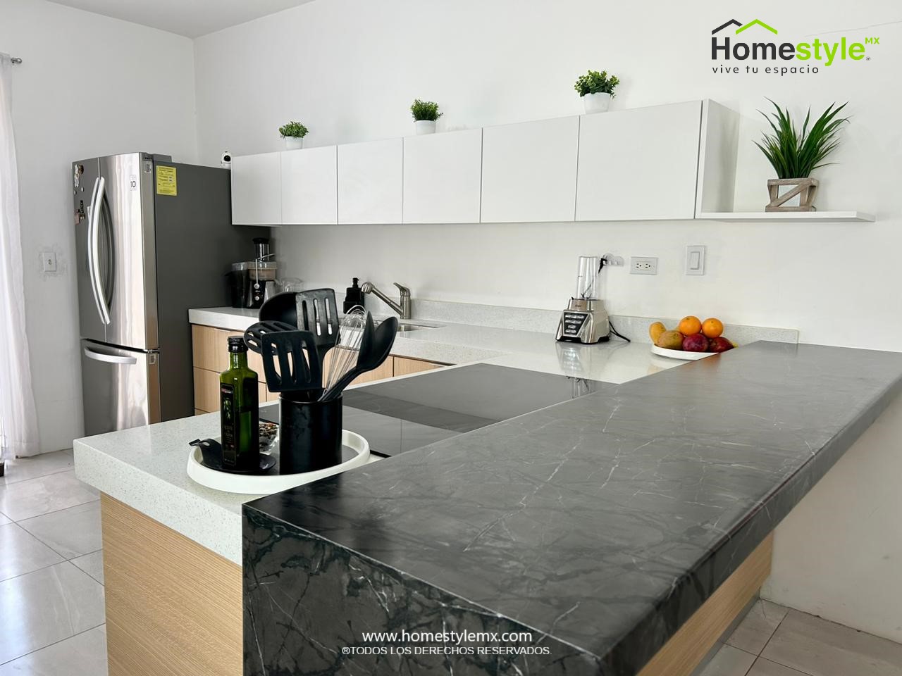 Cocina en forma de L. Diseñada en Melamina Vesto Roble Americano para los gabinetes inferiores y Melamina Blanca para la gabinetería superior. Cubierta de Formaica Kober modelo Essence Cote D Azur Noir con cascada.